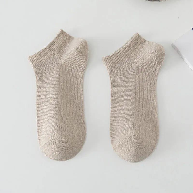 A pair of solid colour low-cut boat socks made from breathable polyester, shown in one of six available colour options.