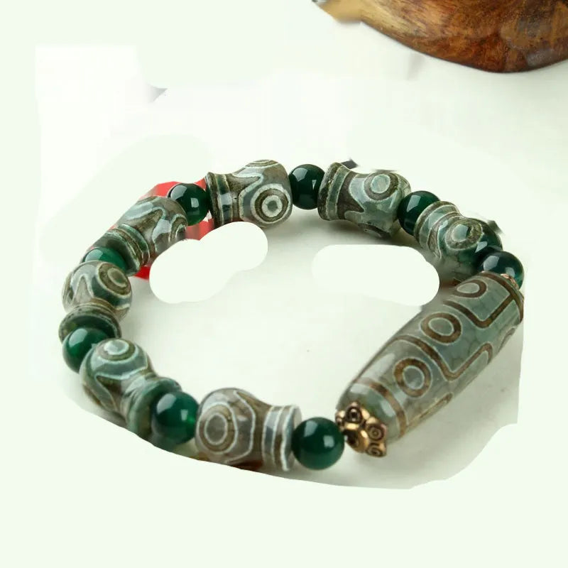 Agate Tibetan dzi bead bracelet with three-eye design and polished finish