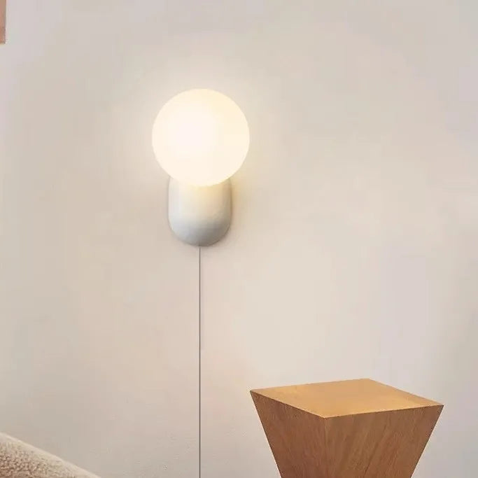Nordic bedside wall lamp in black with acrylic shade and resin body