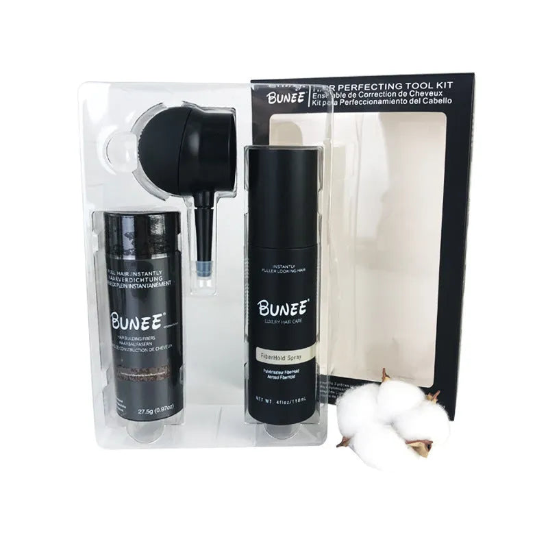 Box containing dense hair fibre powder canister, special applicator nozzle, and shaping spray bottle for hair styling.