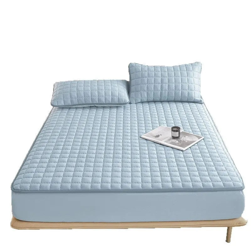 Washed cotton waterproof fitted sheet in light grey colour with elasticated corners on a mattress