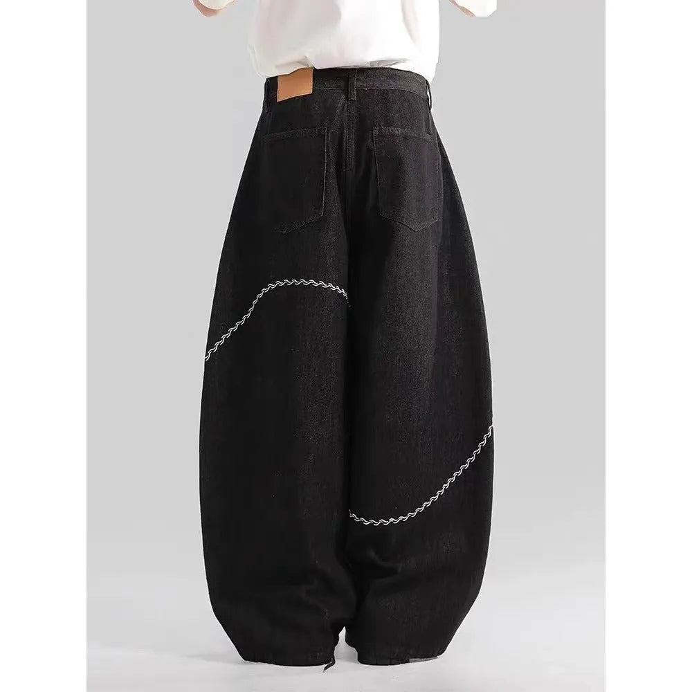 Black straight-leg denim trousers with a mid waist and zip fly, laid flat.