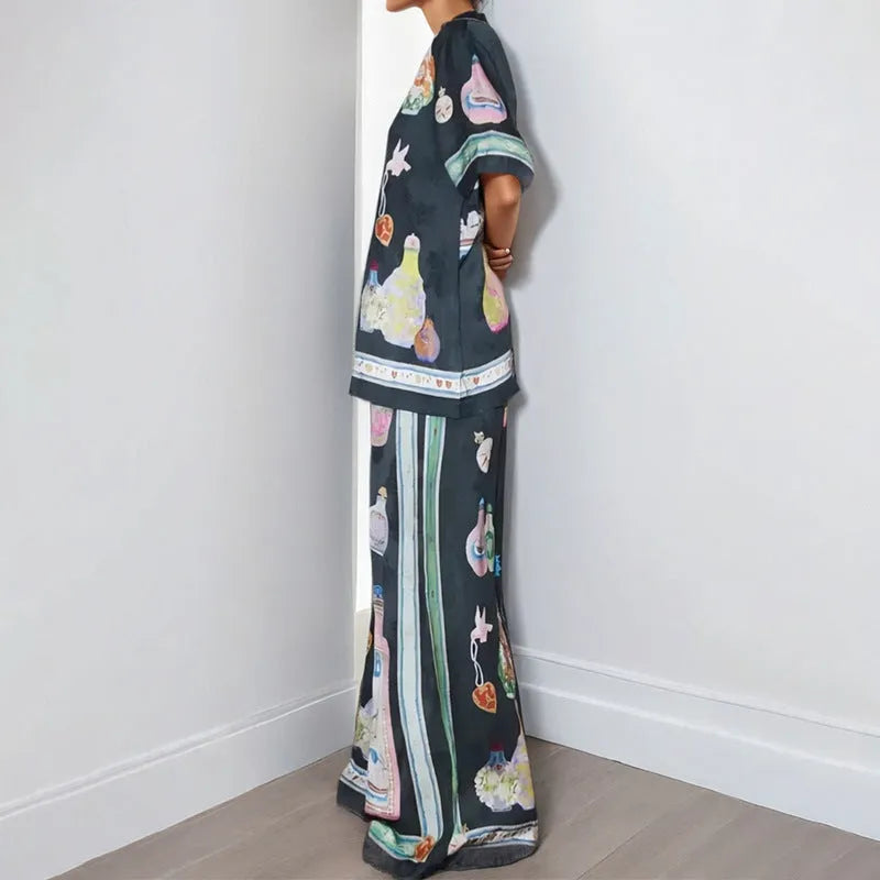 Women's black casual set with cartoon print, featuring a long-sleeve cardigan and matching trousers