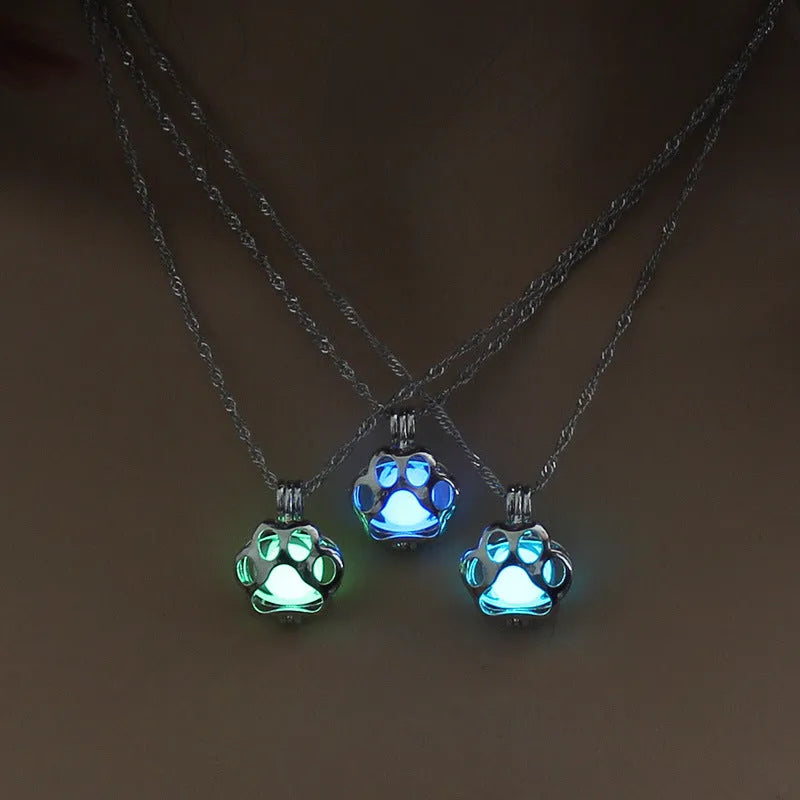 Hollow dog paw luminous alloy necklace with bamboo link chain and pendant, blue green colour option on white background