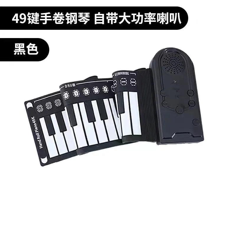 Rolled-up silicone keyboard next to black ABS control unit and speaker for portable 49-key electronic piano.