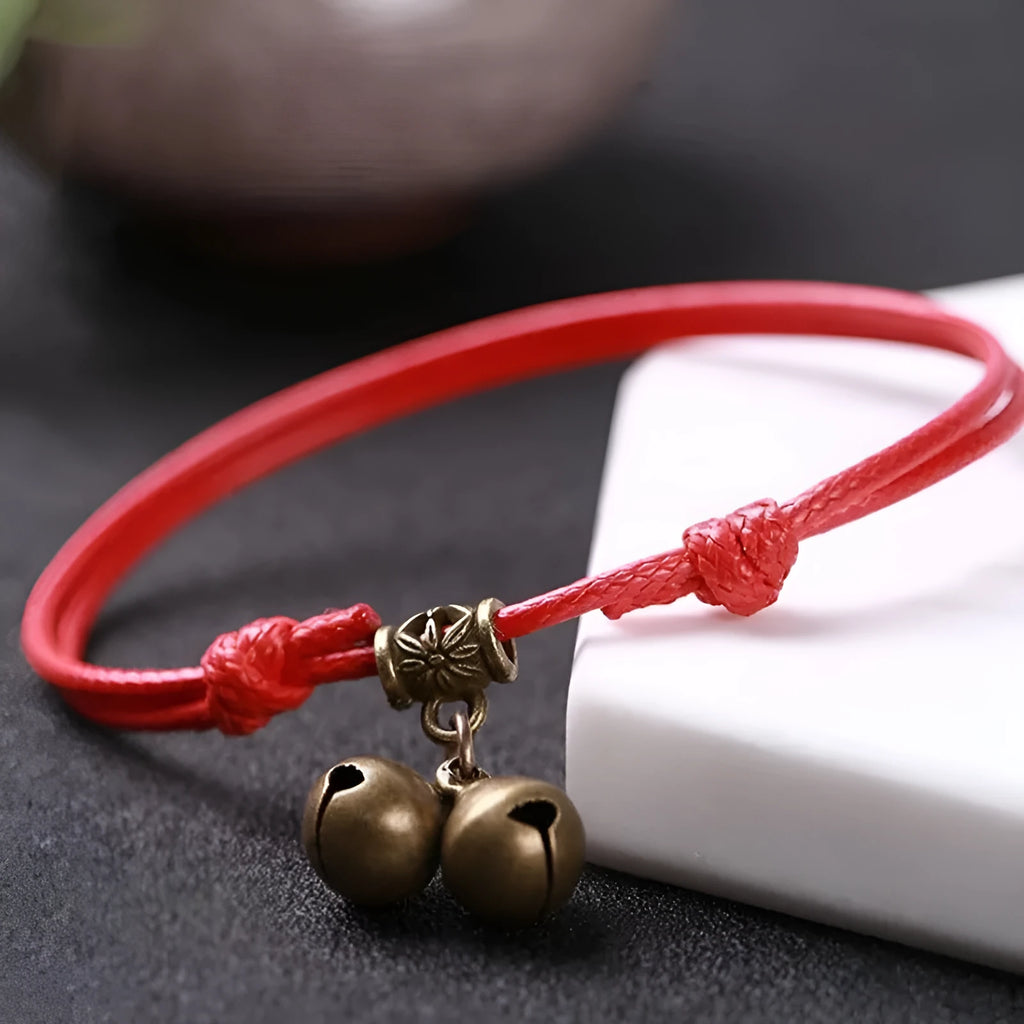 Small dog wearing adjustable nylon rope collar with brass bell in black, red, or coffee colour