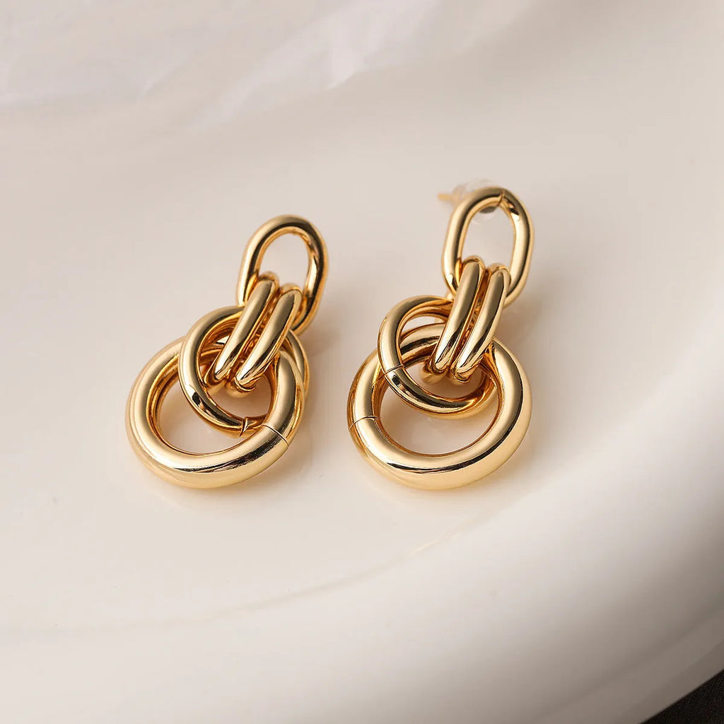 Geometric copper earrings with gold colour finish in irregular shape