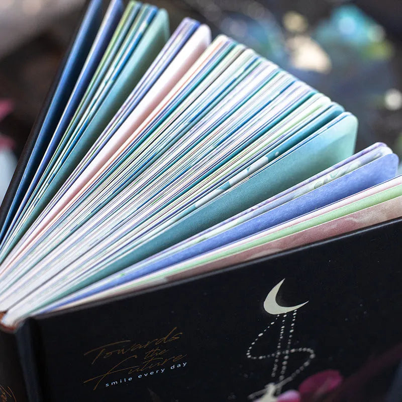 A5 size diary book with a luminous purple cover, open to show pages with colour illustrations.