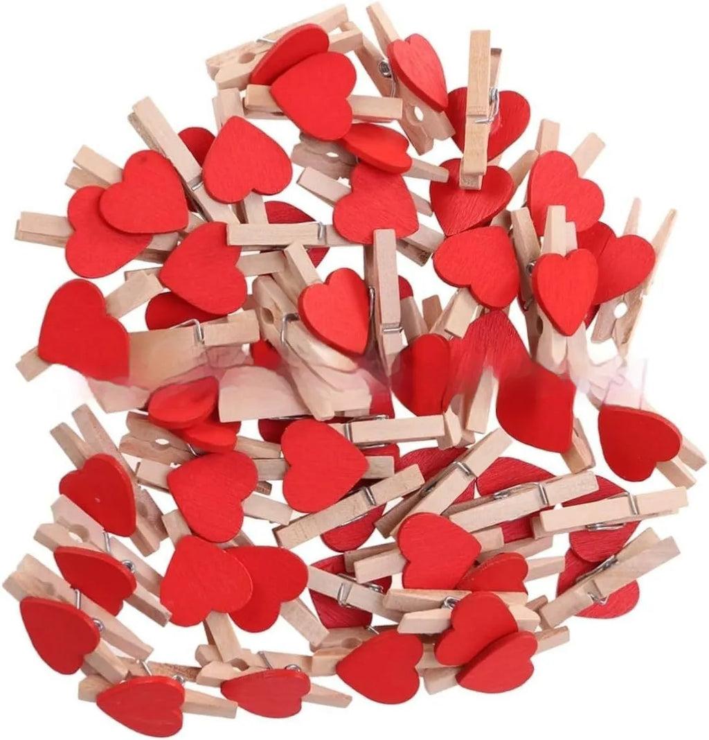 Five solid wood heart-shaped clips in different colours showing handmade construction details