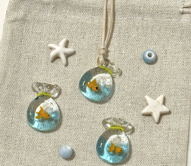 Women's necklace with a coloured glaze skirted joker pendant on a cotton and linen clavicle chain.