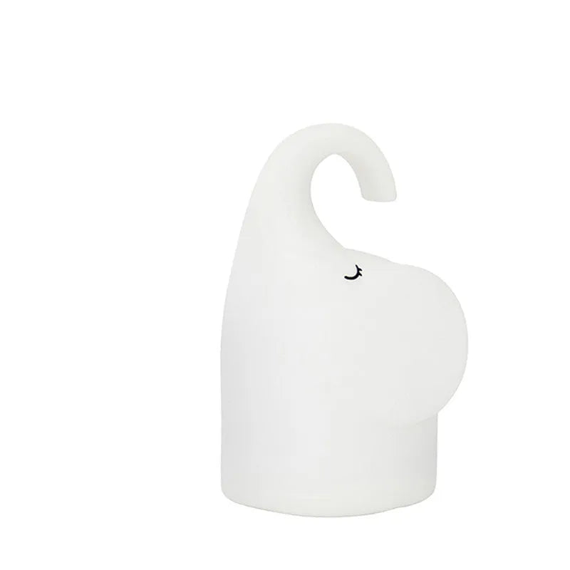 DOMI Elephant-shaped silicone night light with soft white glow on a bedside table