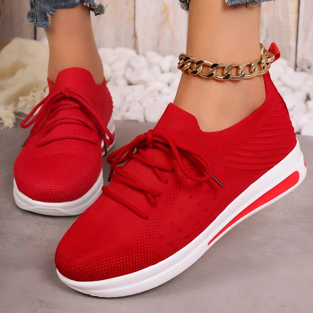 Women's low-top fly-knit sneakers in red colour with front lace-up closure and round-toe design