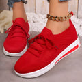 Women's low-top fly-knit sneakers in red colour with front lace-up closure and round-toe design