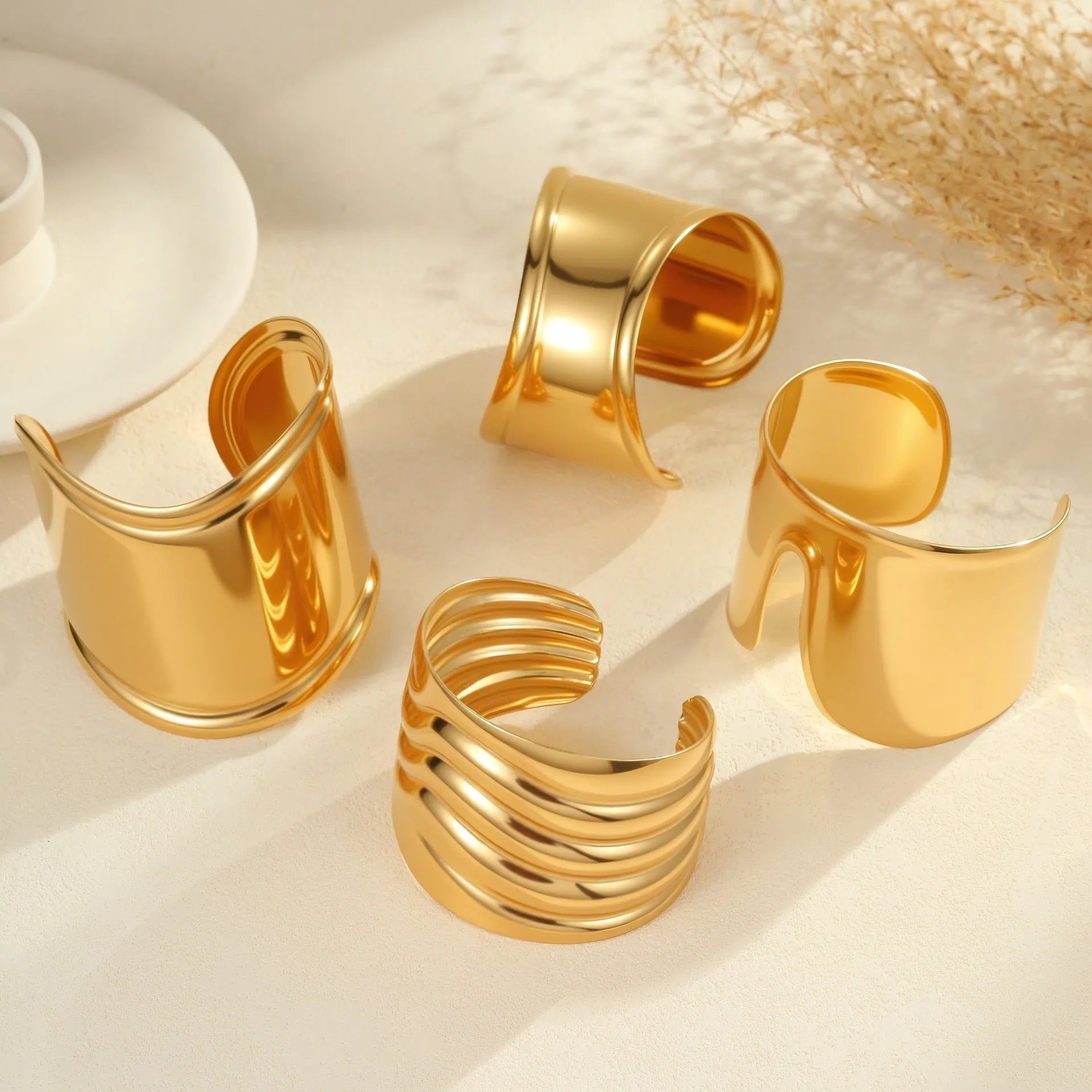 Women's wide fashion bracelet with wave design in gold-plated stainless steel