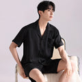 Men's ice silk pyjama set in a black satin jacquard plaid pattern, showing cardigan top and matching shorts.