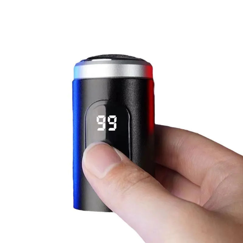 Black mini rechargeable shaver with USB cable and cleaning brush on a table