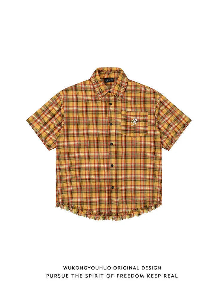 Yellow and white plaid short sleeve shirt with embroidered chest pocket on a hanger.