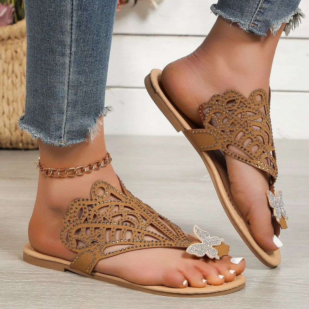 Women's black slip-on sandals with rhinestone details and a flip-toe design