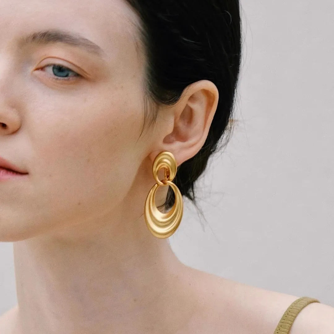 Quicksand gold coloured double circle French retro drop earrings with a U-shaped silhouette.