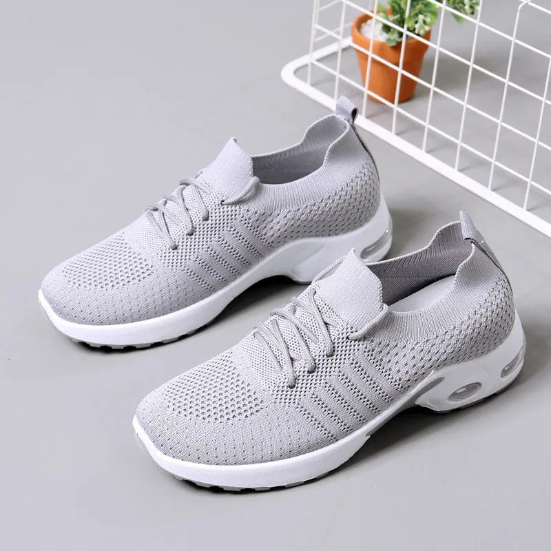 Women's black casual sneakers with mesh upper and non-slip PVC soles, shown with lace-up front closure