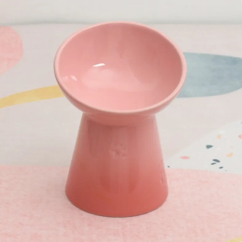 A white ceramic pet bowl with a high foot and raised neck protector to prevent tipping.