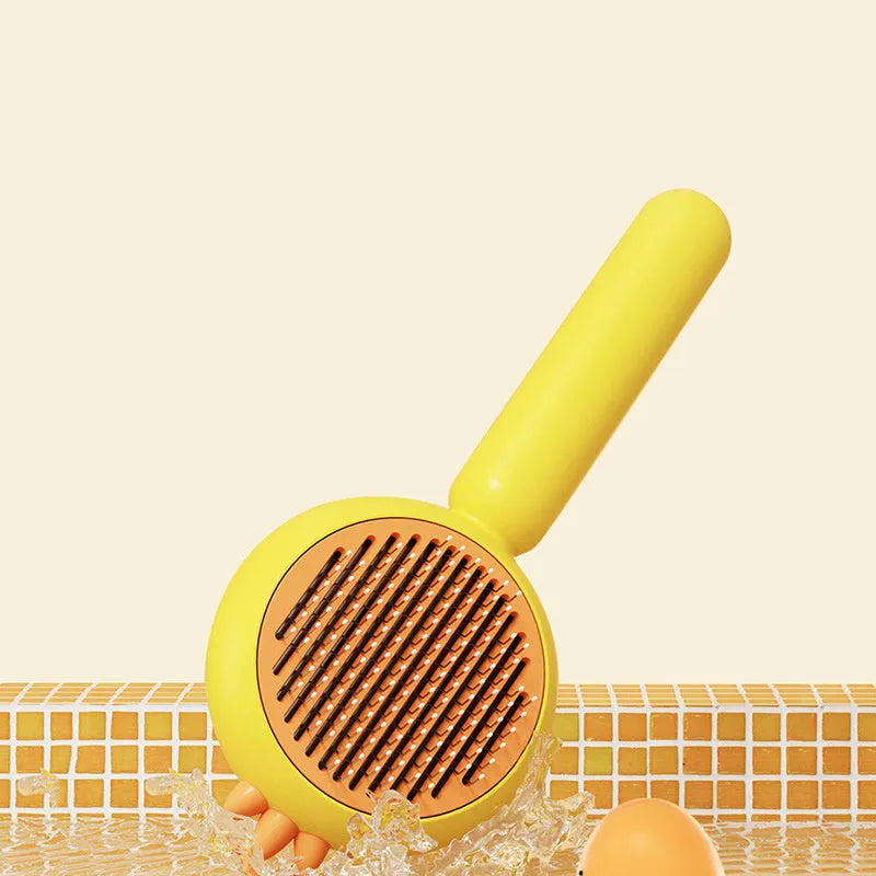 Purple pet grooming brush with self-cleaning button and stainless steel bristles on a white background