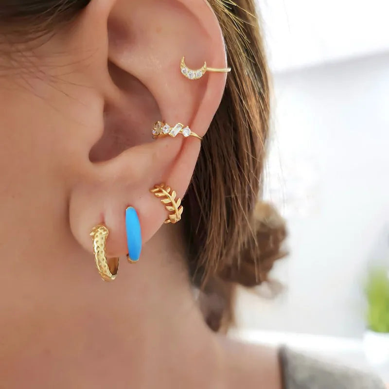 Geometric epoxy resin earrings with dripping oil colour technique showing oval curves and integrated rings