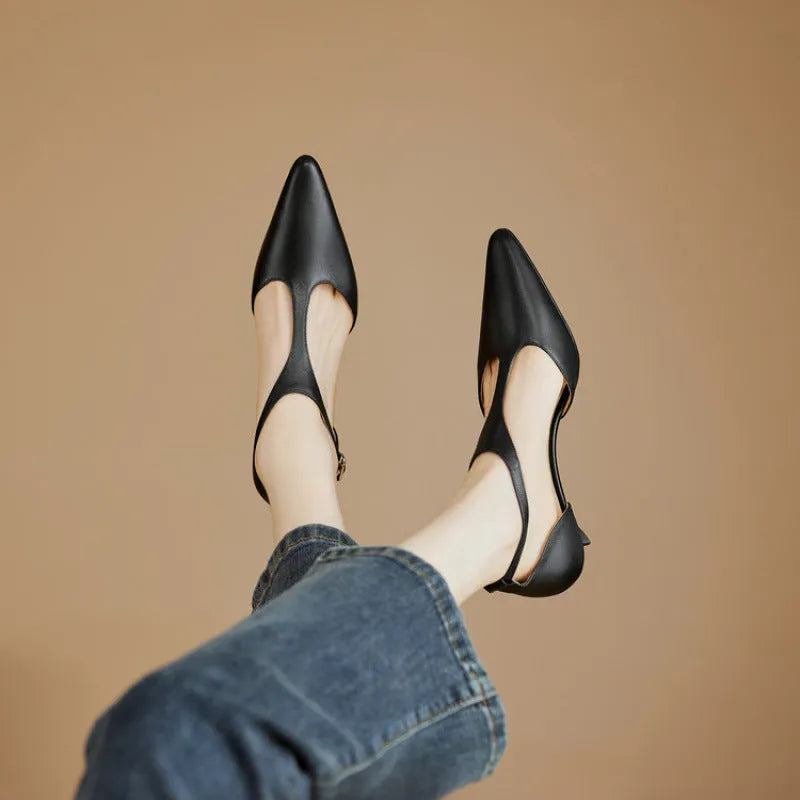 Women's black pointed toe high heels made from cowhide leather.