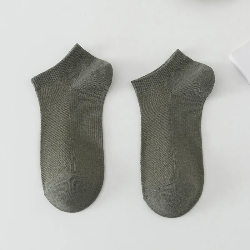 A pair of solid colour low-cut boat socks made from breathable polyester, shown in one of six available colour options.