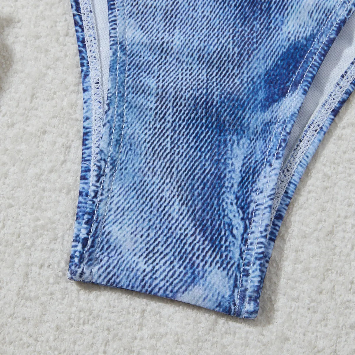 Women's blue denim print strappy bikini set, two-piece swimsuit on a white background.