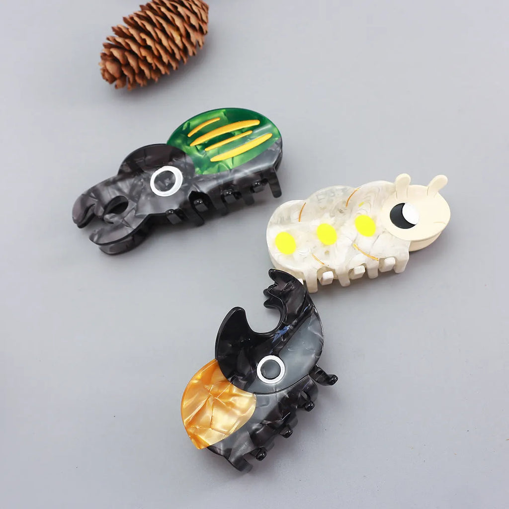Cartoon-style beetle grip insect biology collectable on cellulose acetate sheet