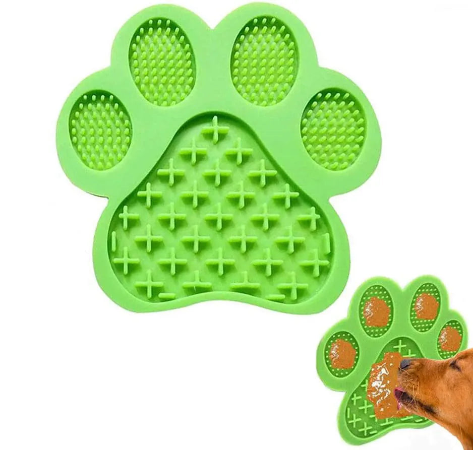 Blue silicone dog licking mat with bone-shape texture and suction cups on a tiled wall.