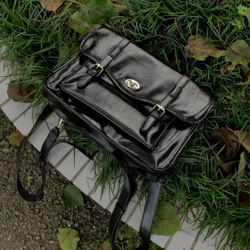 Black college style messenger bag with oil wax leather-look finish showing 35cm length dimensions