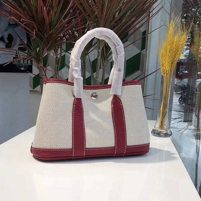 Women's canvas crossbody shoulder tote bag with leather detailing and bucket shape