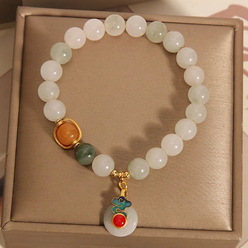 Women's ice jade bracelet with pearl accents and carved Xiangyun peace jade buckle