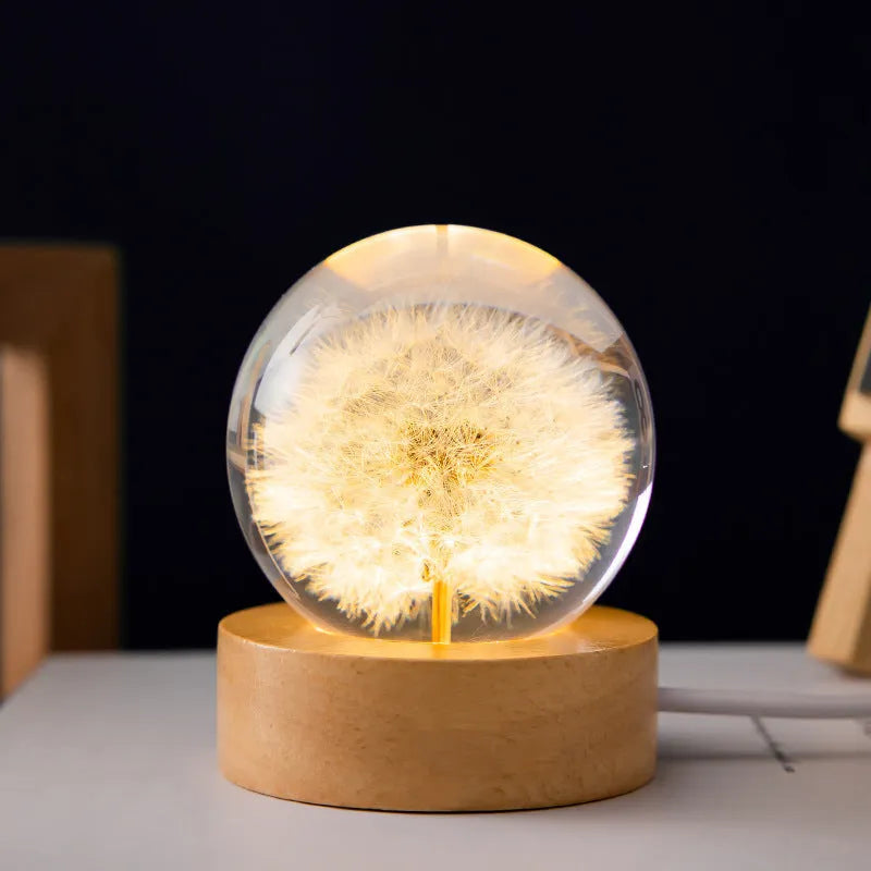 Dandelion eternal flower inside a clear resin crystal ball USB night light on a beech wood stand.
