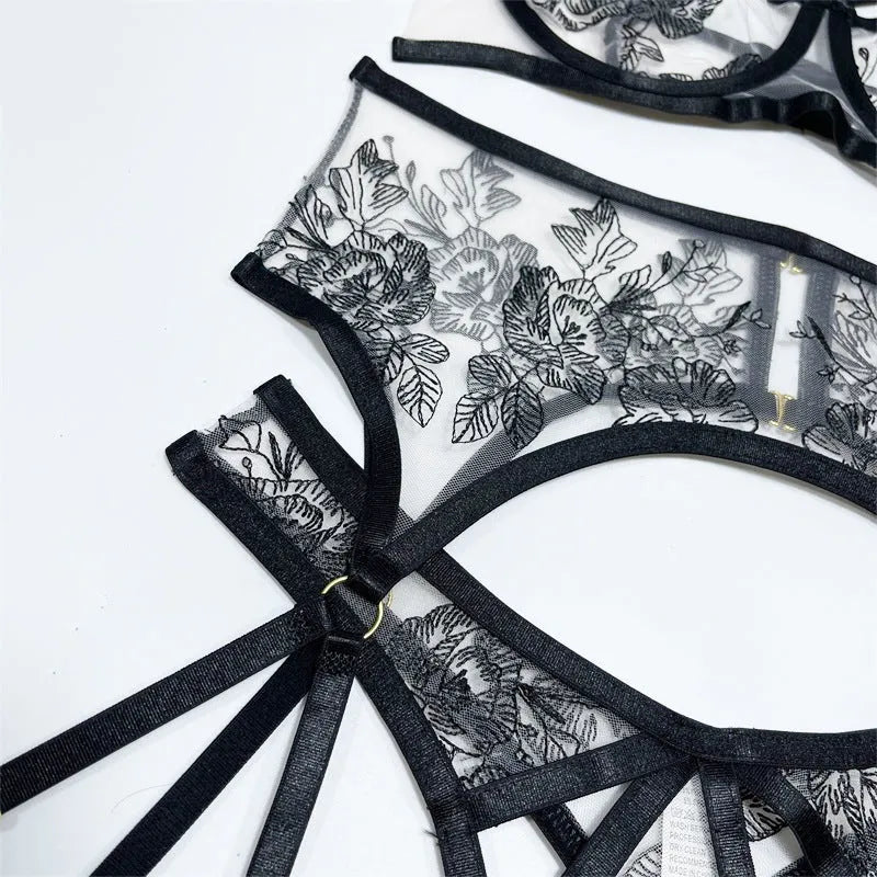 Black women's lace mesh three-piece clothing set with floral print, showing top, trousers, and waist cincher.