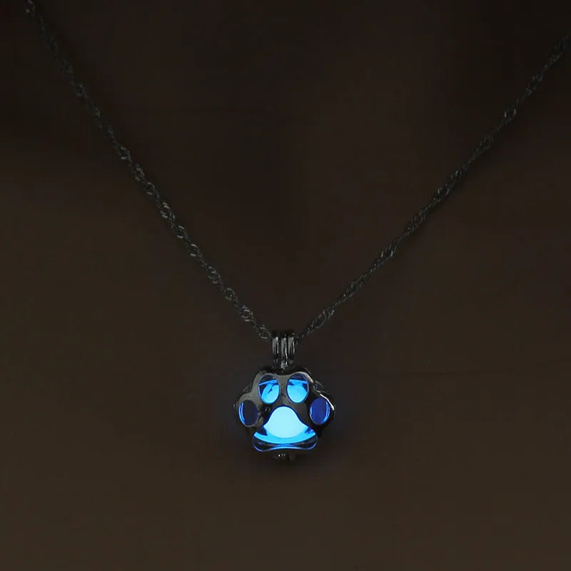 Hollow dog paw luminous alloy necklace with bamboo link chain and pendant, blue green colour option on white background