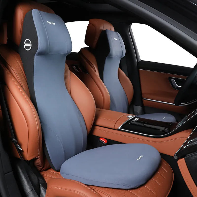 Black automotive memory foam headrest and lumbar cushion combined in one piece on a car seat.
