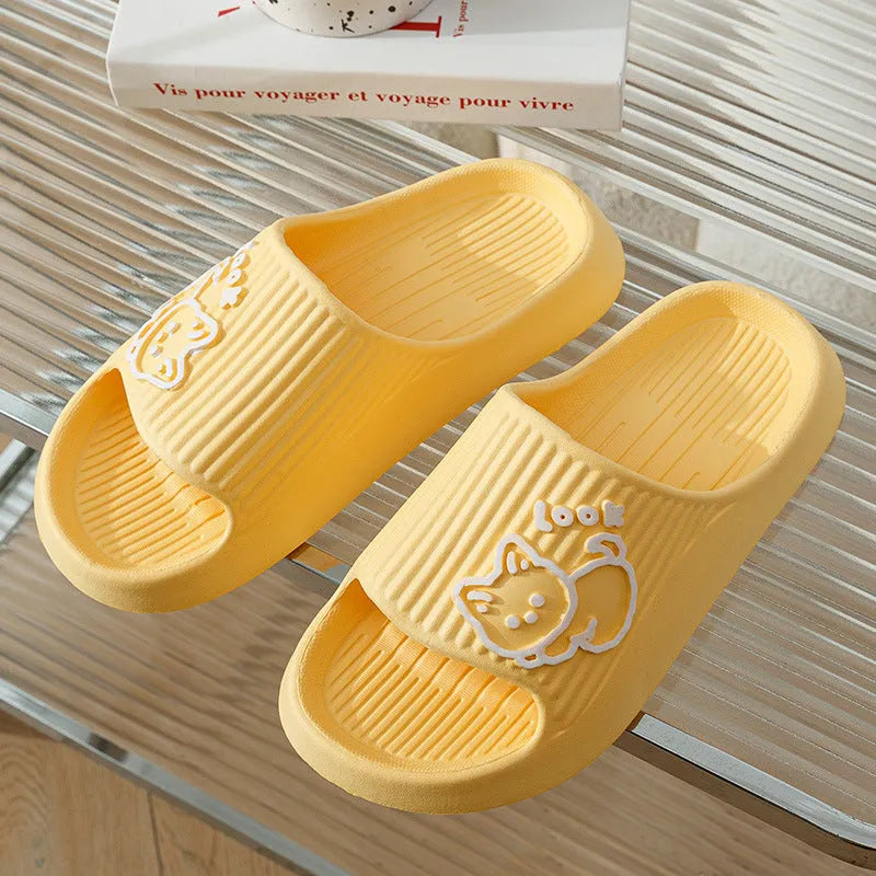 Green cat design thick EVA platform slippers on a wooden floor