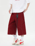 Multi-pocket denim workwear shorts in wide leg cropped style with zipper fly, available in red and black colours