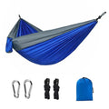 Blue nylon parachute cloth outdoor camping hammock shown in a natural setting.