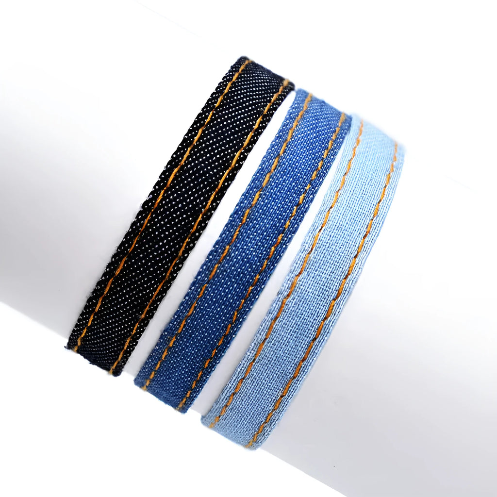 Handmade denim fabric wristband carrying strap in mixed materials with adjustable closure