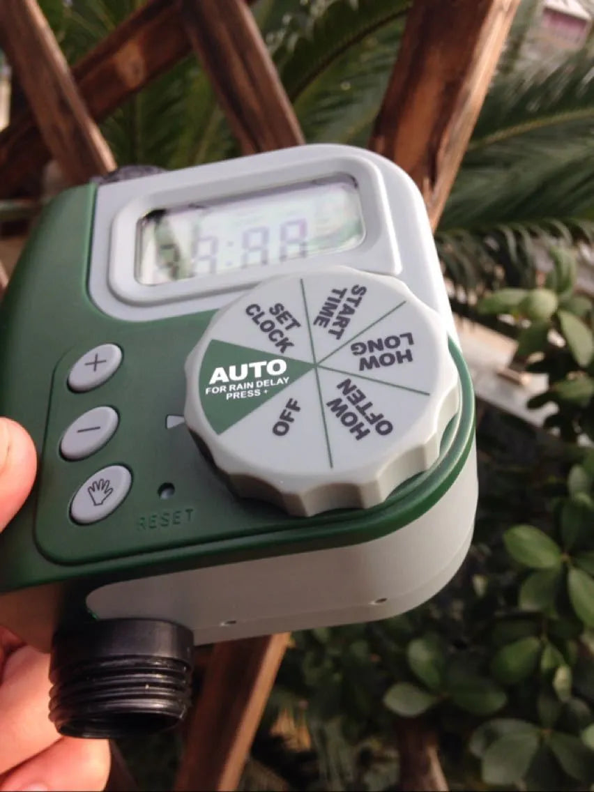 Green digital programmable garden hose faucet timer with copper connector and display