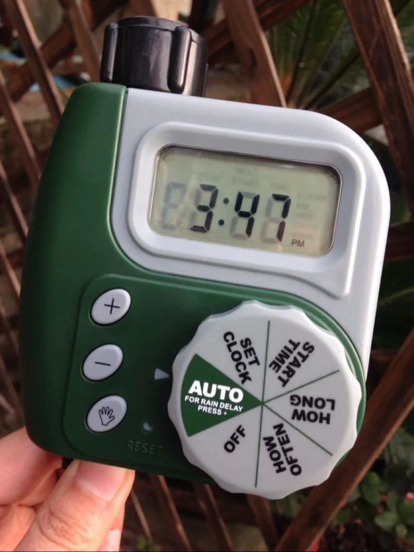 Green digital programmable garden hose faucet timer with copper connector and display
