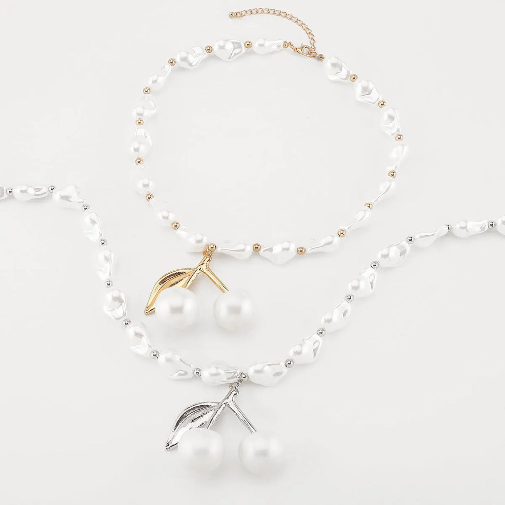 Geometric fruit pendant necklace with pearl chain in gold finish, measuring 51-60cm circumference