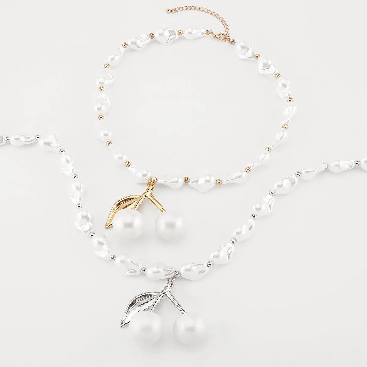 Geometric fruit pendant necklace with pearl chain in gold finish, measuring 51-60cm circumference