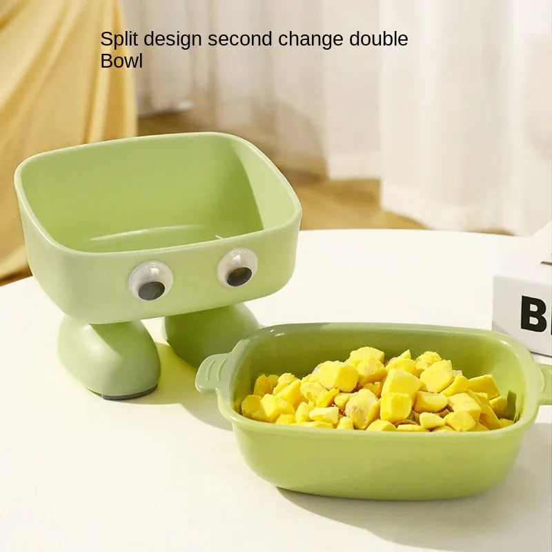 Green robot-shaped elevated cat bowl with tilted dish and anti-slip base.