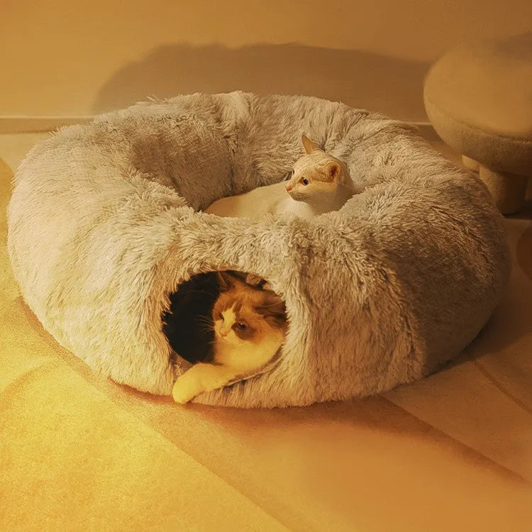 Closed cat tunnel nest 95cm made of long fluffy plush in rainbow colour on a wooden floor
