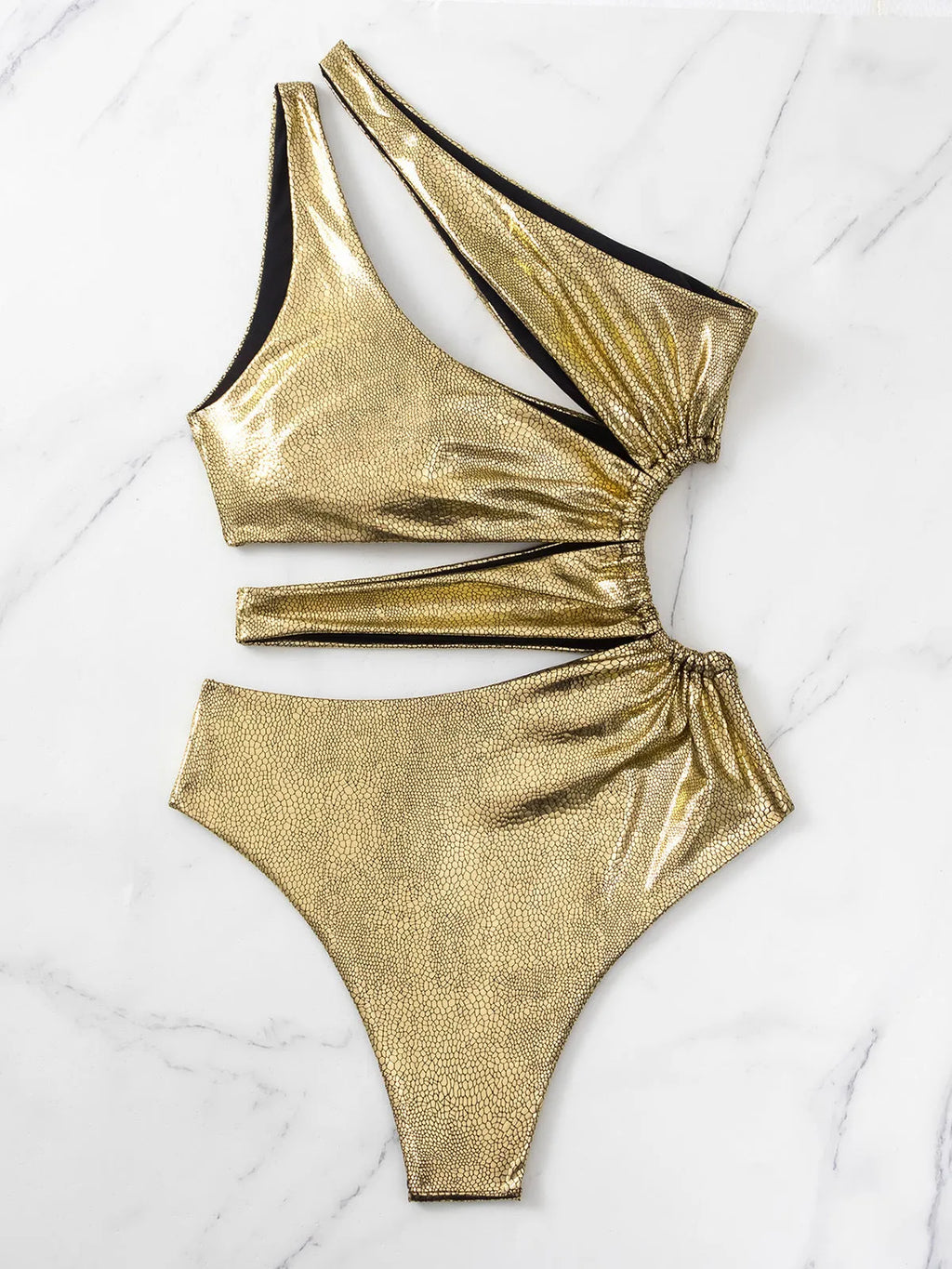 Gold coloured women's backless one-piece swimsuit on a neutral background.